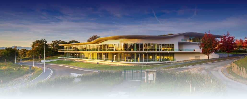ESTIA modern university campus building exterior at dusk